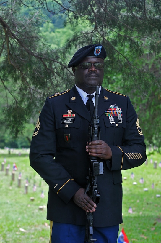U.S. Army Reserve Sgt. 1st Class Cornelius Joyner, Headquarters and Headquarters Company, 412th Theater Engineer Command, based in Vicksburg, Miss., presents arms after he and six other company Soldiers performed a 21-gun salute at the Vicksburg National Cemetery Memorial Day Observance May 29, 2017. (U.S. Army Reserve Photo by Sgt. 1st Class Clinton Wood)