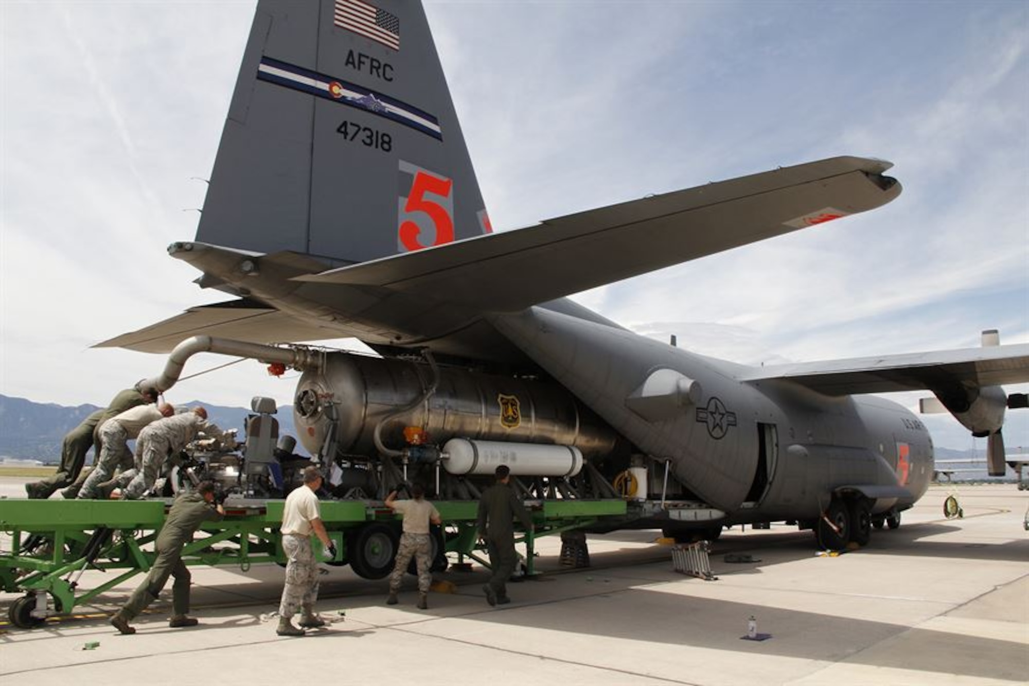 The 302nd Airlift Wing was recently awarded the 2015 Air Force Outstanding Unit Award for its exceptional performance during the period Jan. 1, 2014 through Dec. 31, 2015. The 302nd AW is one of 18 Air Force Reserve units to receive the award during the 2015 award period. Dozens of accomplishments by the wing’s operations, maintenance and support Airmen to include the Wing's Modular Airborne Fire Fighting System mission were recognized. Pictured: Members of the 39th Aerial Port Squadron along with C-130 loadmasters assigned to the 731st Airlift Squadron load a U.S. Forest Service MAFFS unit onto a 302nd AW C-130, Aug. 2, 2015, at Peterson Air Force Base, Colo. MAFFS aircrews and support personnel responded to the U.S. Forest Service MAFFS activation in support of 2015 wildland fire fighting efforts in California and the Northwestern U.S. (U.S. Air Force photo/Staff Sgt. Nathan Federico.)