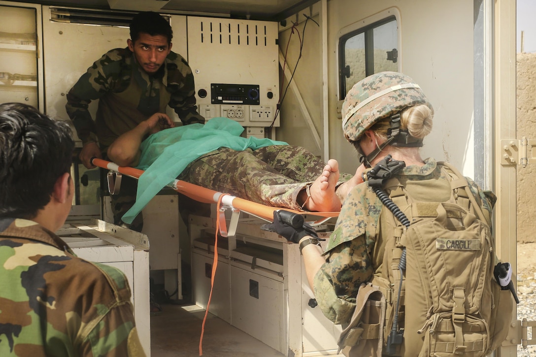 A U.S. sailor, right, with Task Force Southwest and an Afghan soldier prepare to medically evacuate a wounded Afghan soldier at Camp Nolay, Afghanistan, May 23, 2017. The sailor is assigned to Task Force Southwest. Marine Corps photo by Sgt. Lucas Hopkins
