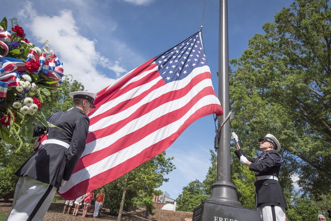 Two Clemson University Reserve Officers’ Training Corps cadets bring in the American flag during a Memorial Day observance in Clemson’s Memorial Park, May 28, 2017. (U.S. Army Reserve photo by Staff Sgt. Ken Scar)
