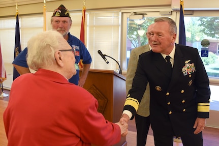U.S. Navy Rear Adm. Daniel Fillion, U.S. Strategic Command director of global operations, speaks with a veteran's wife during a Memorial Day ceremony at the Eastern Nebraska Veterans’ Home in Bellevue, Neb., May 29, 2017. During the event, local leaders joined veterans and members of the Omaha-area community in recognizing the courage, legacy and service of those who gave their lives to guarantee the freedoms and liberties Americans enjoy today. The tradition of honoring fallen war veterans dates back to May 5, 1868, when the head of the Grand Army of the Republic, an organization of Union veterans, established “Decoration Day” as a time for the nation to decorate the graves of the war dead with flowers. The first large observance was held at Arlington National Cemetery, Virginia. In 1971, Memorial Day was declared a national holiday by an act of Congress and was placed on the last Monday of May.