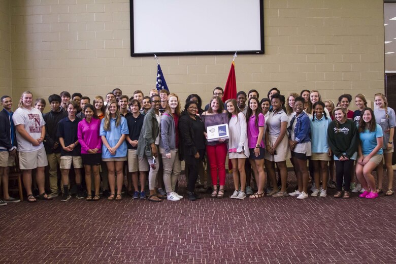 Gracyn LaSueur (center) poses with classmates and teammates after being presented the Semper Fidelis All-American award at Northview High School, May 18, 2017. LaSueur was one of 100 students who will attend the Battles Won Academy this summer in Washington D.C., where she will be given the opportunity to network with and hear from an elite circle of leaders from all walks of life, who like her, have fought and won their own battles. (U.S. Marine Corps photo by Cpl. Krista James/Released)