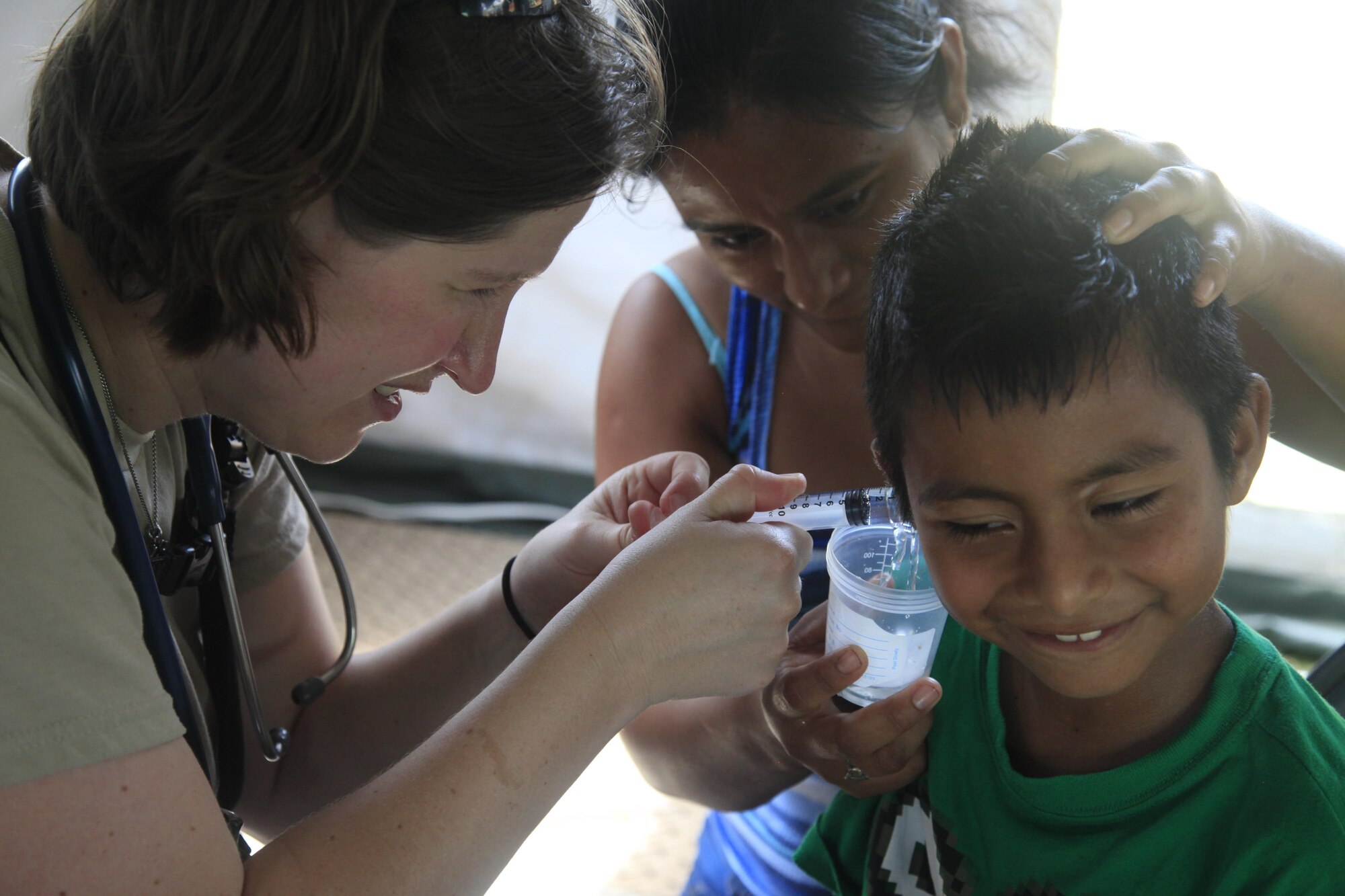 U.S. Air Force Capt. Katie Coble, 96th Medical Group, cleans a patient's ear at a medical readiness event in Dangriga, Belize, May 22, 2017. This is the third and final medical event for medical event scheduled for Beyond the Horizon 2017, a U.S. Southern Command-sponsored, Army South-led exercise designed to provide humanitarian and engineering services to communities in need, demonstrating U.S. support for Belize. (U.S. Army photo by Spc. Kelson Brooks)