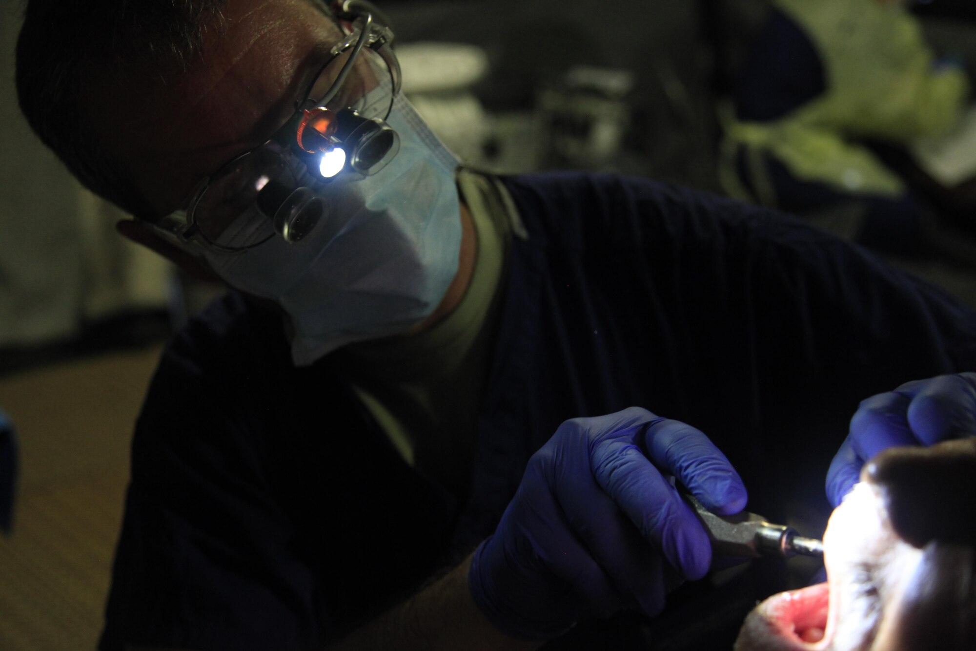 U.S. Air Force Maj. Chris Nuttall, 96th Medical Group, extracts a patient's teeth at a medical readiness event in Dangriga, Belize, May 22, 2017. This is the third and final medical event scheduled for Beyond the Horizon 2017, a U.S. Southern Command-sponsored, Army South-led exercise designed to provide humanitarian and engineering services to communities in need, demonstrating U.S. support for Belize. (U.S. Army photo by Spc. Kelson Brooks)