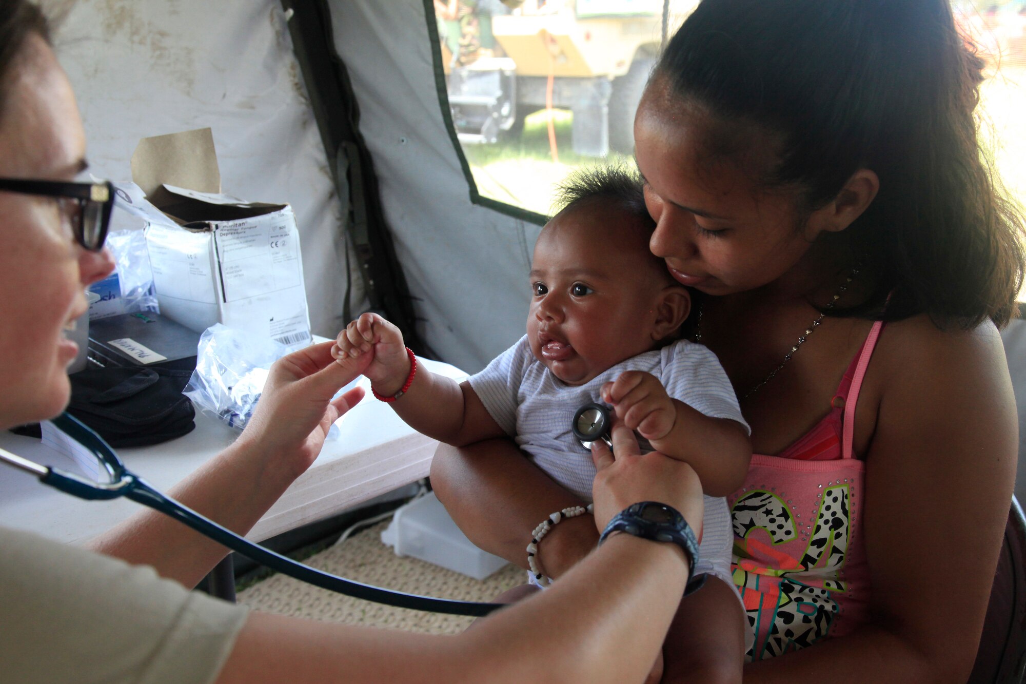 U.S. Air Force Maj. Crystal Palmatier, a pediatrician with the 96th Medical Group, checks a patient's heart beat at a medical readiness event in Dangriga, Belize, May 22, 2017. This is the third and final medical event scheduled for Beyond the Horizon 2017, a U.S. Southern Command-sponsored, Army South-led exercise designed to provide humanitarian and engineering services to communities in need, demonstrating U.S. support for Belize. (U.S. Army photo by Spc. Kelson Brooks) 