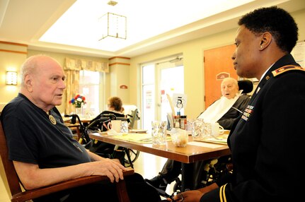 Maj. Angela Reed-Johnson, strategic operations chief for the Directorate of Human Resources for the U.S. Army Reserve’s 99th Regional Support Command at Joint Base McGuire-Dix-Lakehurst, New Jersey, visits May 26 with Frank Gross, a Korean War veteran, at the Veterans Memorial Home in Vineland, New Jersey.  Gross was at the 99th RSC’s dining out on May 12, an event to which dozens of residents from the home were invited.