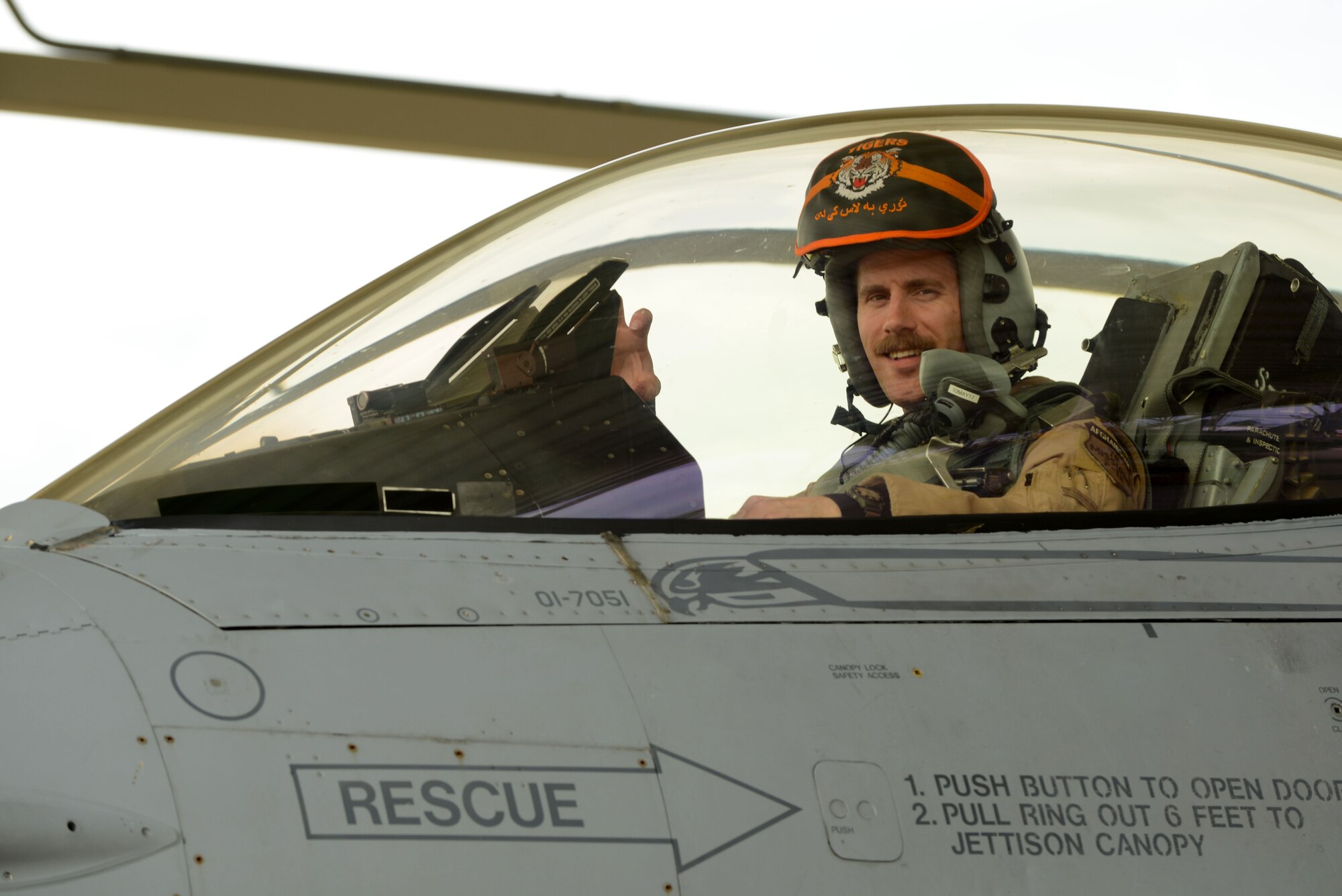 Lt. Col. Craig Andrle, commander of the 79th Fighter Squadron (FS) “Tigers,” bares his “claws” after landing a F-16 Fighting Falcon on the Shaw Air Force Base, S.C., flightline May 4, 2017. While deployed to Bagram Air Base, Afghanistan, Andrle’s leadership enabled the 79th FS to execute 1900 flights, 9,000 hours, 29 troops-in-contact, 104 priority targets and 610 weapons employments without a single civilian casualty. (U.S. Air Force photo by Airman 1st Class Kathryn R.C. Reaves)