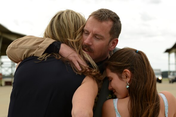 Lt. Col. Craig Andrle, 79th Fighter Squadron (FS) commander, embraces his family on the Shaw Air Force Base, S.C., flightline after returning from a deployment May 4, 2017. As commander, Andrle brought 45 members of the 79th FS with him to Bagram, as well as 300 Shaw maintainers to keep the 79th’s F-16s armed and airworthy. (U.S. Air Force photo by Airman 1st Class Kathryn R.C. Reaves)