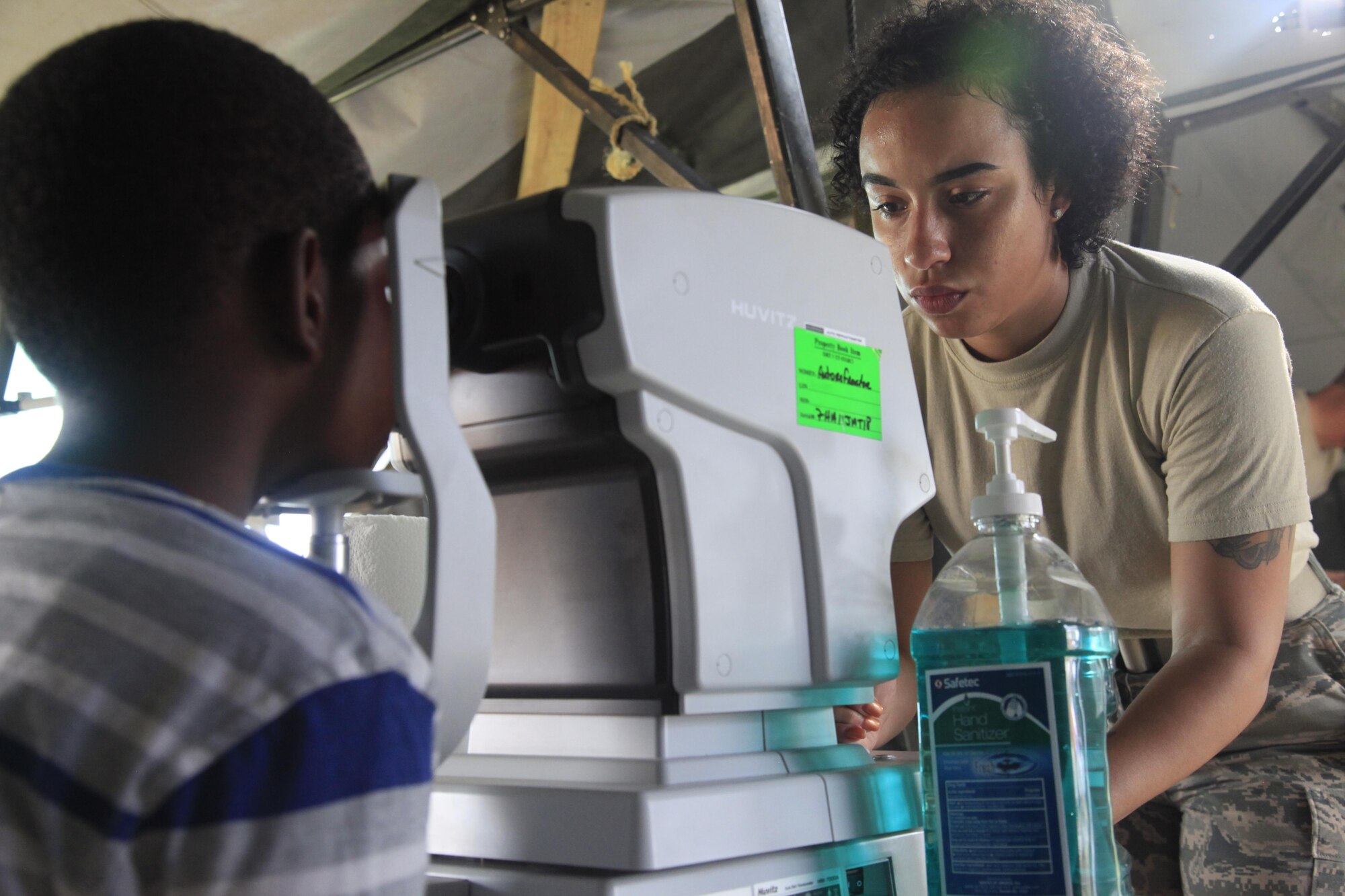 U.S. Air Force Staff Sgt. Brittany Vaughn, 96th Medical Group, examines a patient's eye using a refractormeter, at a medical readiness event in Dangriga, Belize, May 22, 2017. This is the third medical event for Beyond the Horizon 2017, a U.S. Southern Command-sponsored, Army South-led exercise designed to provide humanitarian and engineering services to communities in need, demonstrating U.S. support for Belize. (U.S. Army photo by Spc. Kelson Brooks)