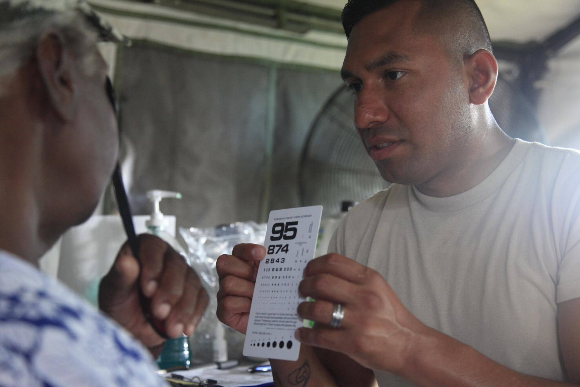 U.S. Air Force Tech Sgt. Benjamin Lemus, 96th Medical Group, checks patient's vision at a medical readiness event in Dangriga, Belize, May 22, 2017. This is the third and final medical event scheduled for Beyond the Horizon 2017, a U.S. Southern Command-sponsored, Army South-led exercise designed to provide humanitarian and engineering services to communities in need, demonstrating U.S. support for Belize. (U.S. Army photo by Spc. Kelson Brooks)