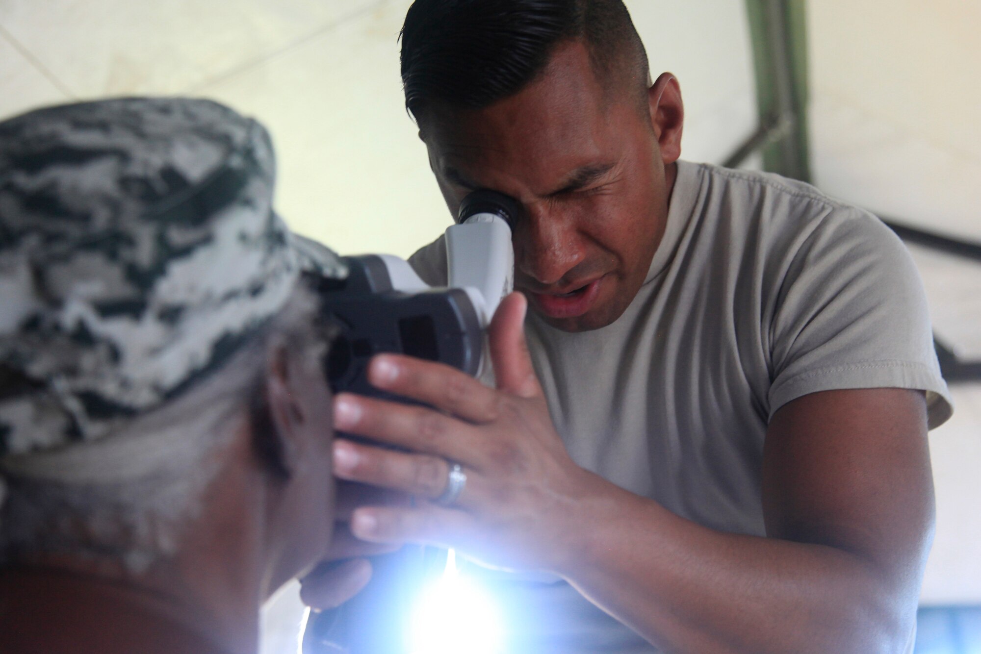 U.S. Air Force Tech Sgt. Benjamin Lemus, 96th Medical Group, evaluates and treats a local resident during Beyond the Horizon 2017. Dangriga is the third and final medical readiness event during BTH 17, which is a U.S. Southern Command-sponsored, Army South-led exercise designed to provide humanitarian and engineering services to communities in need, demonstrating U.S. support for Belize. (U.S. Army photo by Spc. Kelson Brooks)
