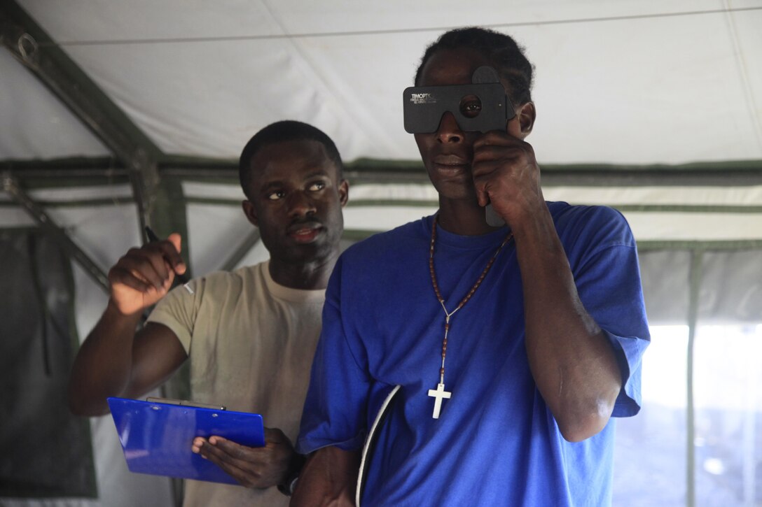 U.S. Air Force Staff Sgt. Kwesi Doamekpor, 96th Medical Group, checks a patient's vision at a medical readiness event in Dangriga, Belize, May 22, 2017. This is the third medical event for Beyond the Horizon 2017, a U.S. Southern Command-sponsored, Army South-led exercise designed to provide humanitarian and engineering services to communities in need, demonstrating U.S. support for Belize. (U.S. Army photo by Spc. Kelson Brooks)