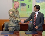 Col. James A. Royce, 470th Military Intelligence Brigade commander, and Dr. C. Mauli Agrawal, University of Texas at San Antonio interim provost and vice president for academic affairs, shake hands after signing the agreement for the pilot internship program at Joint Base San Antonio-Fort Sam Houston May 24.


 