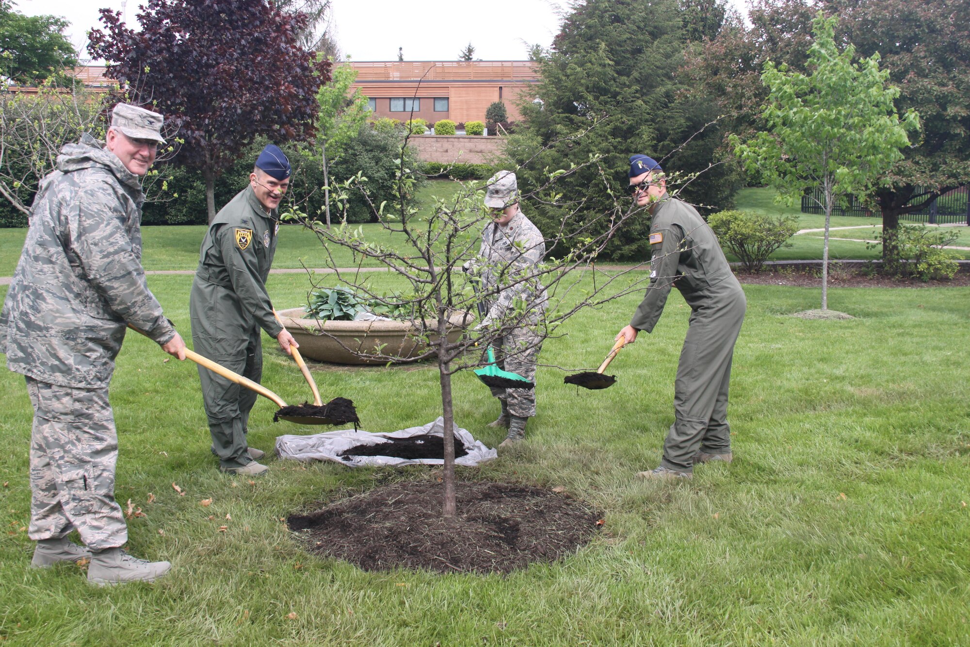 Col. Jeffrey Van Dootingh, commander of the 911th Airlift Wing, Col. Michael Miller, commander of the 911th Operations Group, Maj. Angie Serrao, executive officer with the 911th Mission Support Group, and 1st Lt. Adam Stahl, pilot with the 758th Airlift Squadron, celebrate Earth Day 2017 with the 22nd annual tree planting at the Pittsburgh International Airport Air Reserve Station, Pa., May 4, 2017.  This year a tree was planted in Lane Park.