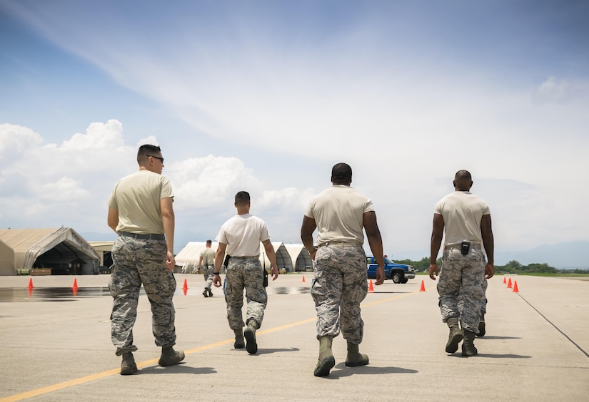 U.S. Air Force Airmen of the 612th Air Base Squadron Firefighters pick up cones after training with the fire trucks and vehicles at Joint Task Force-Bravo, May 12th, 2017. The Commander of the 612th ABS participates in a 24-hour shift to understand the training requirements and operational stress to be a firefighter. (U.S. Air Force photo by Senior Airman Julie Kae/released)