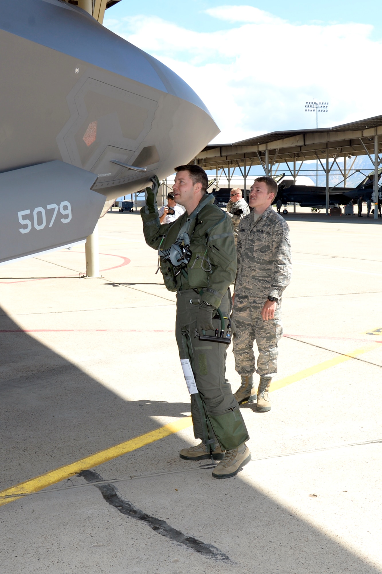 Lt. Col. Dave DeAngelis, an F-35 Lightning II pilot assigned to the 419th Operations Group, and Airman 1st Class Michael Wilkins, a crew chief assigned to the 34th Aircraft Maintenance Unit,  prepare for flight May 22 at Hill Air Force Base, Utah. The flight in aircraft 5079 was the 3,000th operational F-35 sortie flown at Hill. (U.S. Air Force/Todd Cromar)