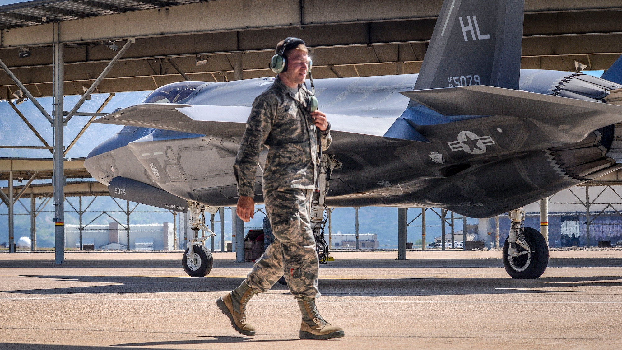 Airman 1st Class Michael Wilkins, a crew chief assigned to the 34th Aircraft Maintenance Unit, walks toward a sun shade after launching an F-35 Lightning II aircraft, number 5079, at Hill Air Force Base, Utah, May 22. In addition to the sortie being the 3,000th in an operational F-35 at Hill, it also turned out to be Wilkens’s first solo launch. (U.S. Air Force/Paul Holcomb)