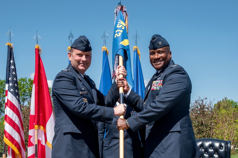 PETERSON AIR FORCE BASE, Colo. – Col. Doug Schiess, 21st Space Wing commander, passes the 21st Operation Group guidon to Col. Devin Pepper, 21st Operations Group commander, during the group’s change of command ceremony at Peterson Air Force Base, Colo., May 30, 2017. Pepper assumed command of 21st OG, Air Force Space Command's largest, most weapon-system diverse and geographically separated operations group. The group provides real-time missile warning, attack assessment and space control to the President, Secretary of Defense, Joint Chief of Staff, combatant commands and foreign allies. (U.S. Air Force photo by Senior Airman Dennis Hoffman)