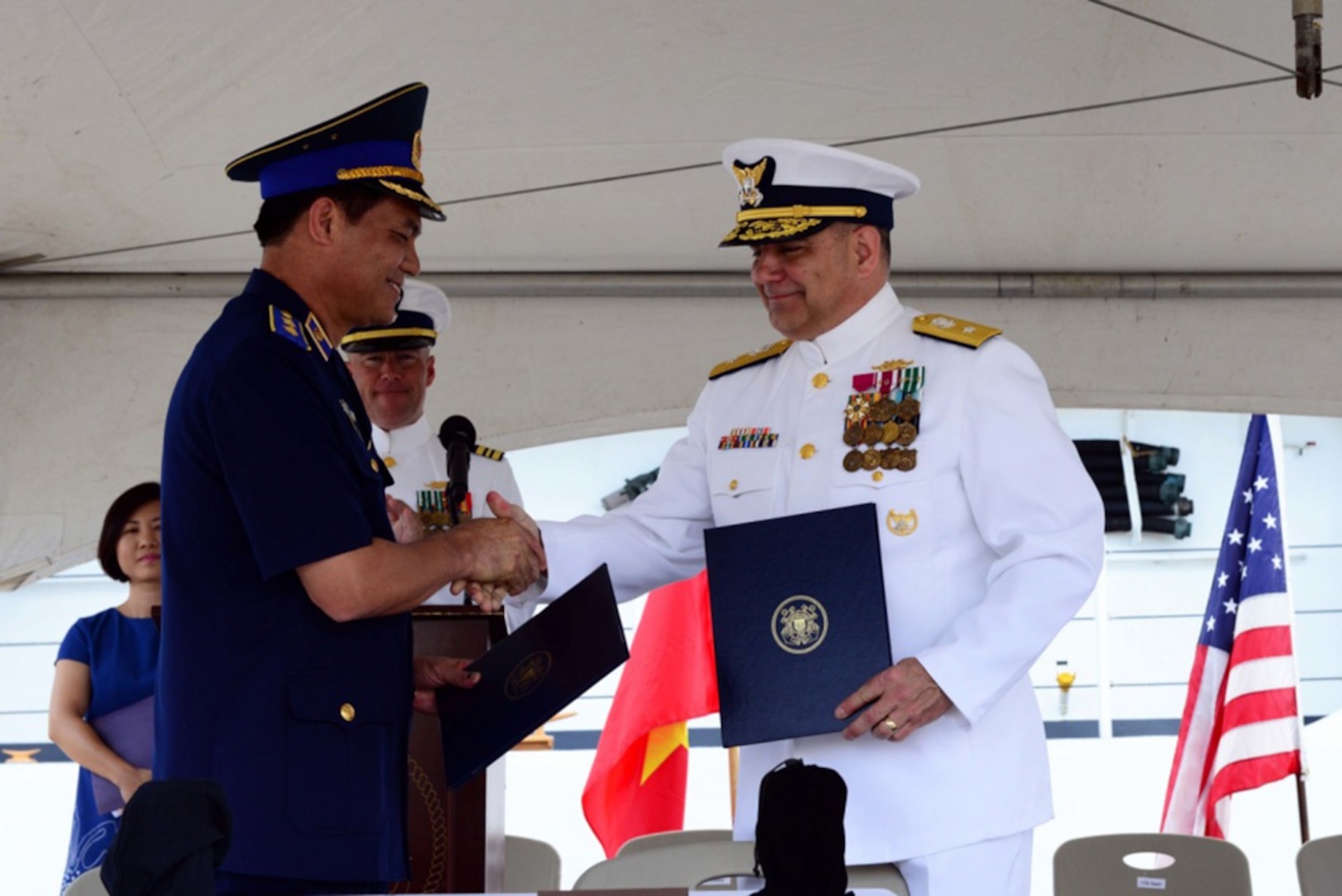 Lt. Gen. Nguyen Quang Dam, commandant, Vietnam coast guard, and Rear Adm. Michael J. Haycock, assistant commandant for acquisition and chief acquisition officer, U.S. Coast Guard, shake hands during a transfer ceremony at Coast Guard Base Honolulu, May 25, 2017. The cutter, now CSB-8020, will continue to serve the maritime community on the opposite side of the Pacific. 