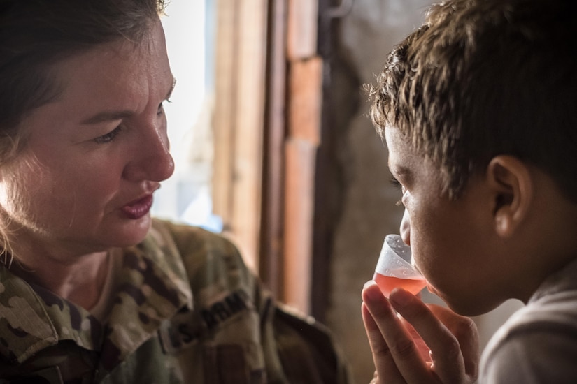 U.S. Army Lt. Col. Rhonda Dyer, Joint Task Force - Bravo, gives deworming medication to a local Honduran child while out on a Community Health Nurse mission in Comayagua, Honduras, May 10, 2017. The CHM is a weekly partnership with the staff at Jose Ochoa Public Health Clinic, administering vaccines, Vitamins, deworming medication and other medical supplies to over 180 Hondurans around the Comayagua area on May 10, 2017.  (U.S. Air National Guard photo by Master Sgt. Scott Thompson/released)