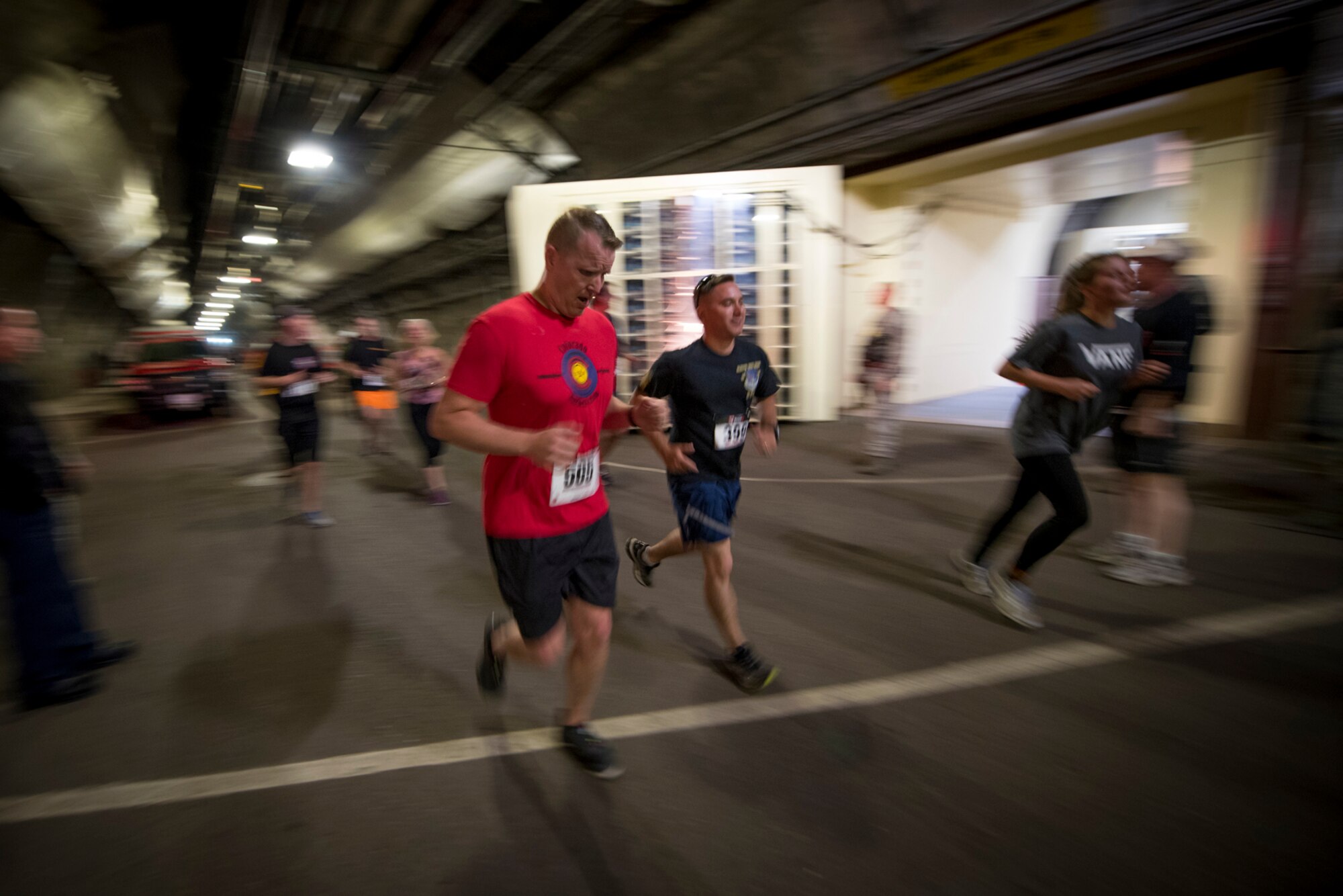CHEYENNE MOUNTAIN AIR FORCE STATION, Colo. – Runners participating in the Memorial Day 5k Tunnel Run sprint past the main blast doors inside Cheyenne Mountain Air Force Station, Colo., May 25, 2017. The blast doors of CMAFS weight in at 23 ton. (U.S. Air Force photo by Airman 1st Class Dennis Hoffman)