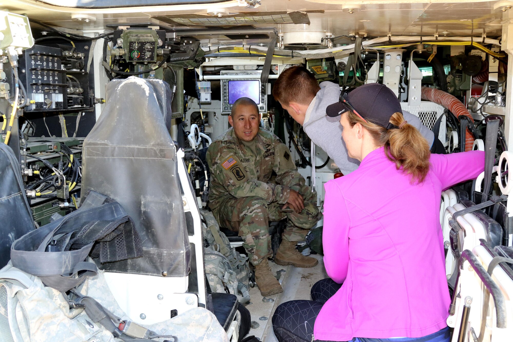CHEYENNE MOUNTAIN AIR FORCE STATION, Colo. - Sgt. Mathew Azevedo, infantry team leader, with 1st Stryker Brigade Combat Team, 4th Infantry Division, gives a tour inside his Stryker Armored Combat Vehicle to Kristen Washburn and her son Owen, just before the Memorial Day 5K Tunnel Run at Cheyenne Mountain Air Force Station. The U.S. Air Force 721st Security Forces Squadron hosted the annual Memorial Day 5K Tunnel Run on May 25, 2017. (U.S. Army photo by Staff Sgt. Christopher Perkey)