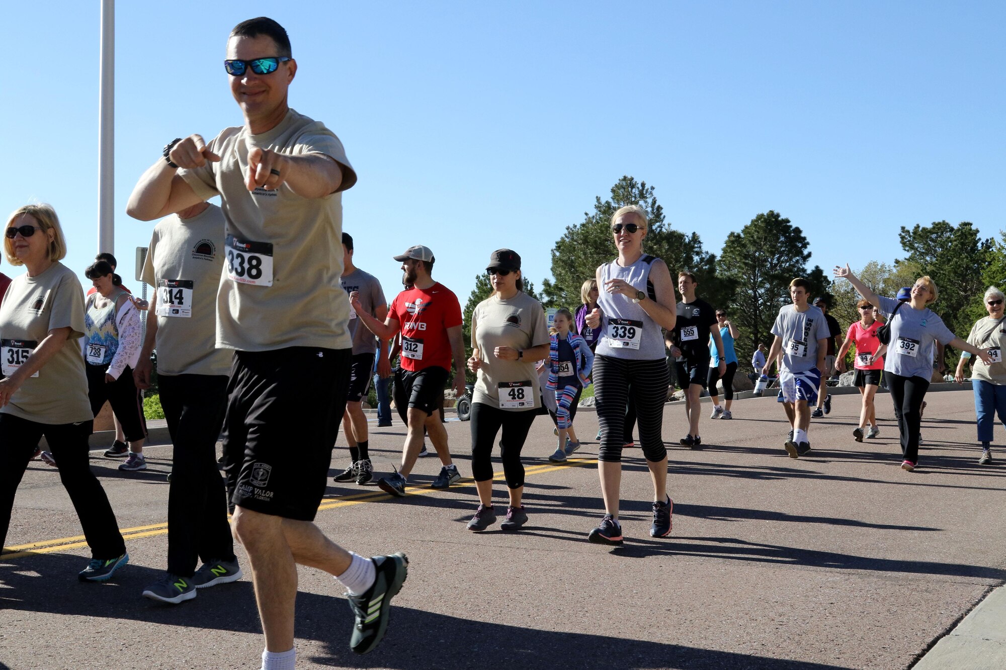 CHEYENNE MOUNTAIN AIR FORCE STATION, Colo. - Sgt. 1st Class Travis McKee (bib 338) and his wife Kimberly (bib 339) start the Memorial Day 5K Tunnel Run in high spirits held at Cheyenne Mountain Air Force Station representing 299 Brigade Engineer Battalion, 1st Stryker Brigade, 4th Infantry Division. Security was tight as more than 400 people participated in the event. The U.S. Air Force 721st Security Forces Squadron hosted the annual Memorial Day 5K Tunnel Run on May 25, 2017. (U.S. Army photo by Staff Sgt. Christopher Perkey)