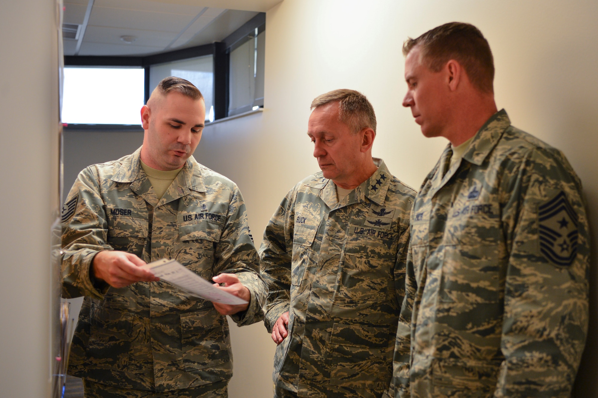Tech. Sgt. William Moser, 460th Medical Operations Squadron dental technician, informs Lt. Gen. David J. Buck, Commander, 14th Air Force (Air Forces Strategic), Air Force Space Command; and Commander, Joint Functional Component Command for Space, U.S. Strategic Command, and Chief Master Sgt. Craig A. Neri, Command Chief Master Sergeant, 14th Air Force, AFSTRAT; and Command Senior Enlisted Leader, JFCC Space, of the current process the Buckley Dental Clinic is enhancing to minimize appointment no-shows. Buck and Neri both spent the day walking through units, learning about the several improvements each are making. (U.S. Air Force photo by Airman 1st Class Holden. S. Faul/ Released)