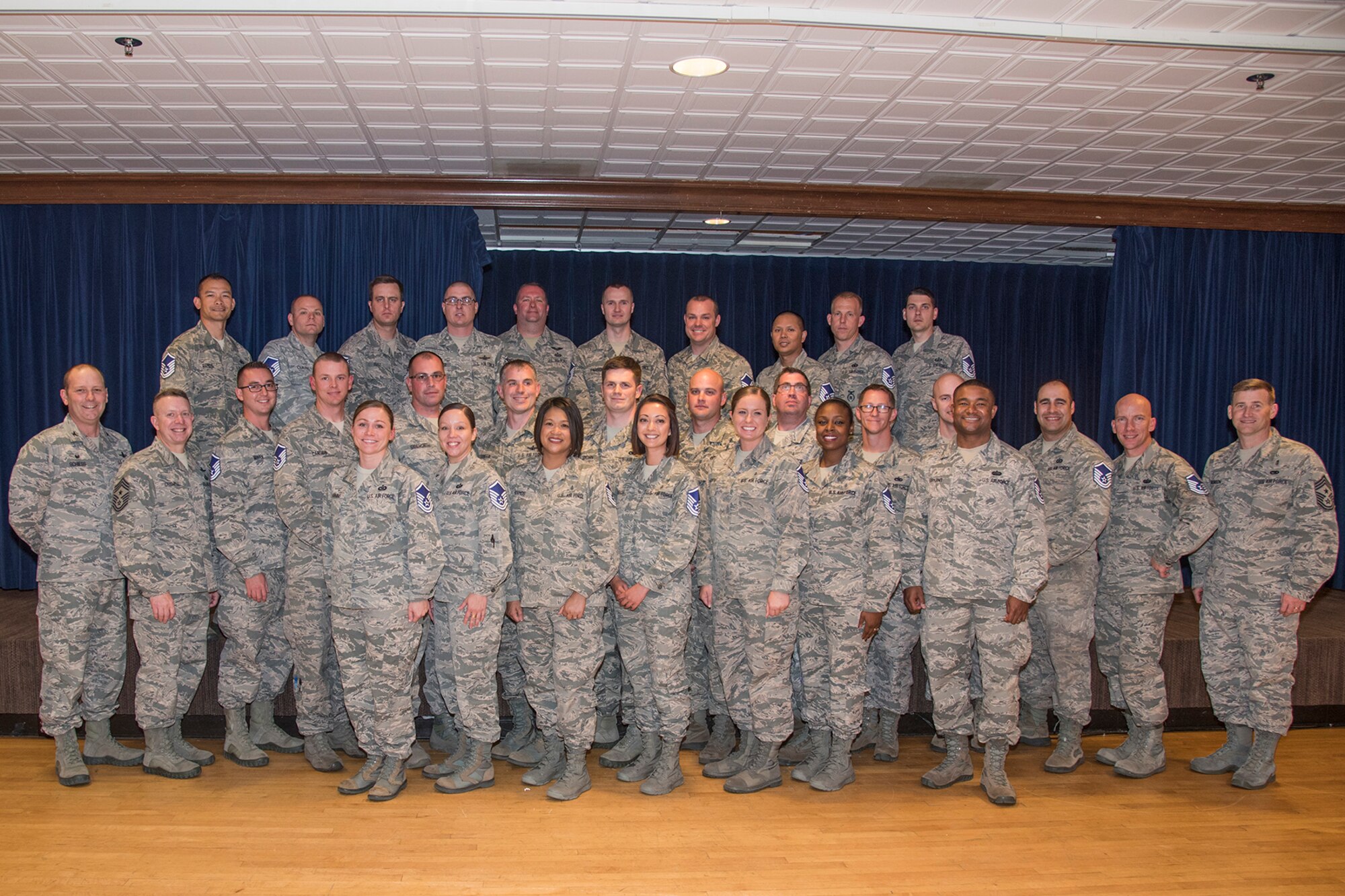 Col. Doug Schiess, 21st Space Wing commander, and Chief Master Sgt. Mark Bronson, 21st SW command chief, congratulates Team Pete’s newest master sergeant selects during the Master Sgt. Release Ceremony at The Club, May 24, 2017, at Peterson Air Force Base, Colo. The Air Force selected 5,166 technical sergeants for the promotion of master sergeant, May 24. (U.S. Air Force photo by Staff Sgt. Tiffany Lundberg)