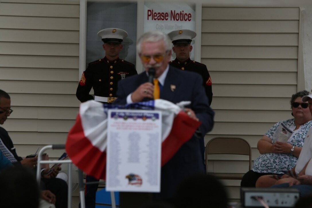 Jim Gentile, the project liaison for the Colp Plaza Veterans Memorial Committee, gives a speech to guests, May 27, at the Colp Area Veterans Celebration, Dedication and Remembrance Ceremony, in Colp, Illinois. The speech honored fallen service members and four African American Marines from Colp, who were among the first black Americans to join Marine Corps during World War II. Nearly 20,000 African-Americans joined the Marine Corps in 1942, after President Franklin D. Roosevelt issued a “presidential directive giving African Americans an opportunity to be recruited in the Marine Corps,” according to the Montford Point Marines Association website. They didn’t receive recruit training at San Diego or Parris Island, however, but Camp Montford Point, N.C., a segregated training site for African American Marine recruits. For the next seven years, the camp remained opened until it became desegregated. The four Marines are Sol Griffin, Jr.; James L. Kirby, Early Taylor, Jr. and Archibald Mosley. These Marines, among many other Montford Point Marines across the country, were awarded the Congressional Gold Medal, the highest award that can be given to a civilian by Congress, in 2012. (U.S. Marine Corps photo by Gunnery Sgt. Bryan A. Peterson) 