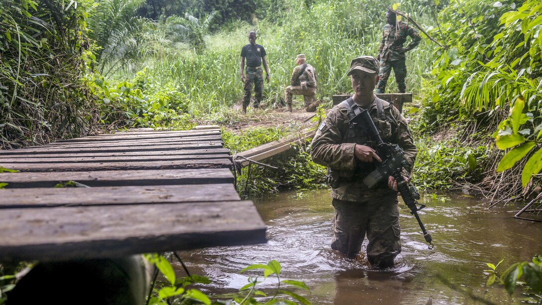Army Spc. Jake Burley maneuvers through a river at the Jungle Warfare School during United Accord 2017 at Achiase military base, Akim Oda, Ghana, May 26, 2017. Burley is assigned to 1st Battalion, 506th Infantry Regiment, 1st, Brigade Combat Team, 101st Airborne Division. Army photo by Sgt. Brian Chaney