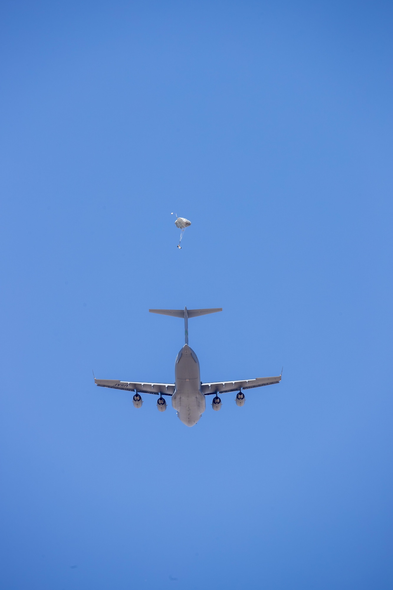 A parachute test dummy exits a C-17 Globemaster III and begins it's descent to earth under guidance of a Remotely Piloted Parachute System. This was the maiden flight of the RPPS. (U.S. Air Force photo by Christian Turner)