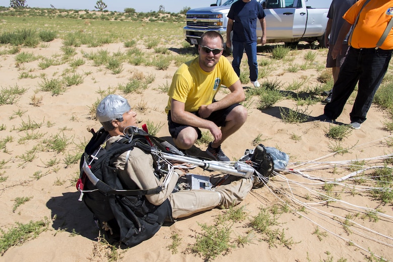 Trever Bush, 412th OSS Parachute Test Team, examines the Remotely Piloted Parachute System after its maiden flight May 23. Bush designed and built the guidance system using off-the-shelf parts like electrically operated servos and a radio control system much like one for a model airplane. (U.S. Air Force photo by Christian Turner)