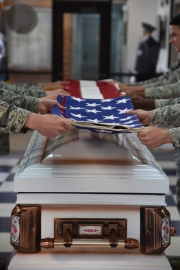U.S. Air Force High Frontier Honorguardsmen perform a six man flag fold during their graduation at Peterson Air Force Base, Colorado, Friday, May 19, 2017. The graduation displayed their honor guard training, as well as recognized team members with awards and certificates. (U.S. Air Force photo/Robert Lingley)