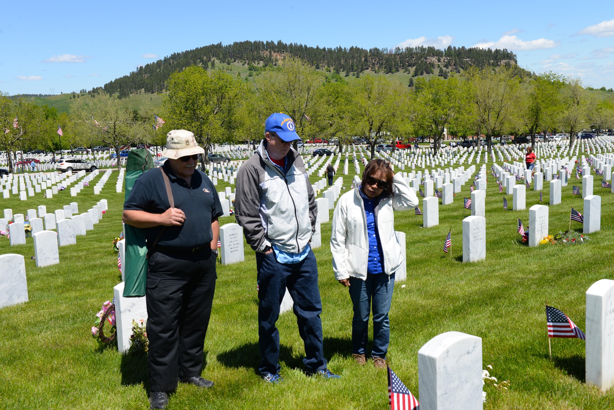 A family visits their loved one buried at the Black Hills National Cemetery, S.D., May 29, 2017. Families come from all over the United States to see their family members on Memorial Day to remember and honor them. (U.S. Air Force photo by Airman Nicolas Z. Erwin)