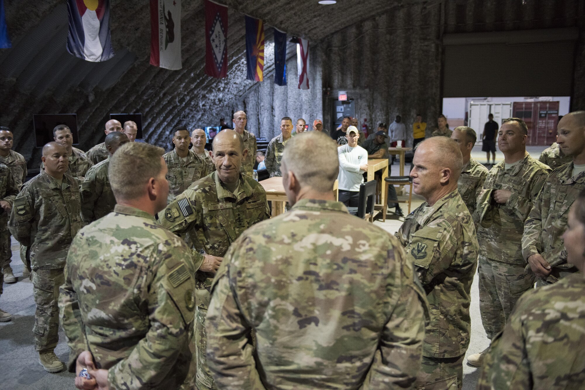Gen. Mike Holmes, commander of Air Combat Command, and Chief Master Sgt. Frank H. Batten III, ACC command chief, speaks to 332nd Air Expeditionary Wing Airmen during a troop visit May 21, 2017, in Southwest Asia. As part of the tour Holmes visited Airmen and their work centers. (U.S. Air Force photo/Senior Airman Damon Kasberg)