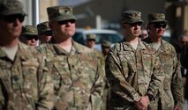 Airmen attend a Memorial Day ceremony at Bagram Airfield, Afghanistan, May 29, 2017. During the ceremony, Bagram Airmen portrayed three fallen comrades, telling the story of how they made the ultimate sacrifice. (U.S. Air Force photo by Staff Sgt. Benjamin Gonsier)
