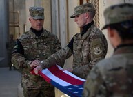 Bagram Honor Guard members unravel the American flag during a Memorial Day ceremony at Bagram Airfield, Afghanistan, May 29, 2017. Memorial Day, observed on the last Monday of May, serves as a day for remembering service members who have died while serving. (U.S. Air Force photo by Staff Sgt. Benjamin Gonsier)
