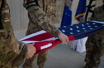 Bagram Honor Guard members fold the American flag during a Memorial Day ceremony at Bagram Airfield, Afghanistan, May 29, 2017. During the ceremony, Bagram Airmen portrayed three fallen comrades, telling the story of how they made the ultimate sacrifice. (U.S. Air Force photo by Staff Sgt. Benjamin Gonsier)
