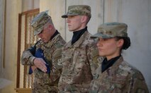 Senior Master Sgt. Michael Miller, 455th Expeditionary Communications Squadron, secures the American flag during a Memorial Day ceremony at Bagram Airfield, Afghanistan, May 29, 2017. During the ceremony, Bagram Airmen portrayed three fallen comrades, telling the story of how they made the ultimate sacrifice. (U.S. Air Force photo by Staff Sgt. Benjamin Gonsier)