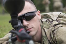 U.S. Army Sgt. Kevin Stanewicz, a Delta Detachment, 1st Space Company, Joint Tactic Army Ground Station engagement control team leader, scans the area with a paintball gun during tactical training at Misawa Air Base, Japan, May 24, 2017. While some members rendezvoused to share information, others stood guard and watched for enemy movement. They used paintball guns to simulate live fire. (U.S. Air Force photo by Airman 1st Class Sadie Colbert)