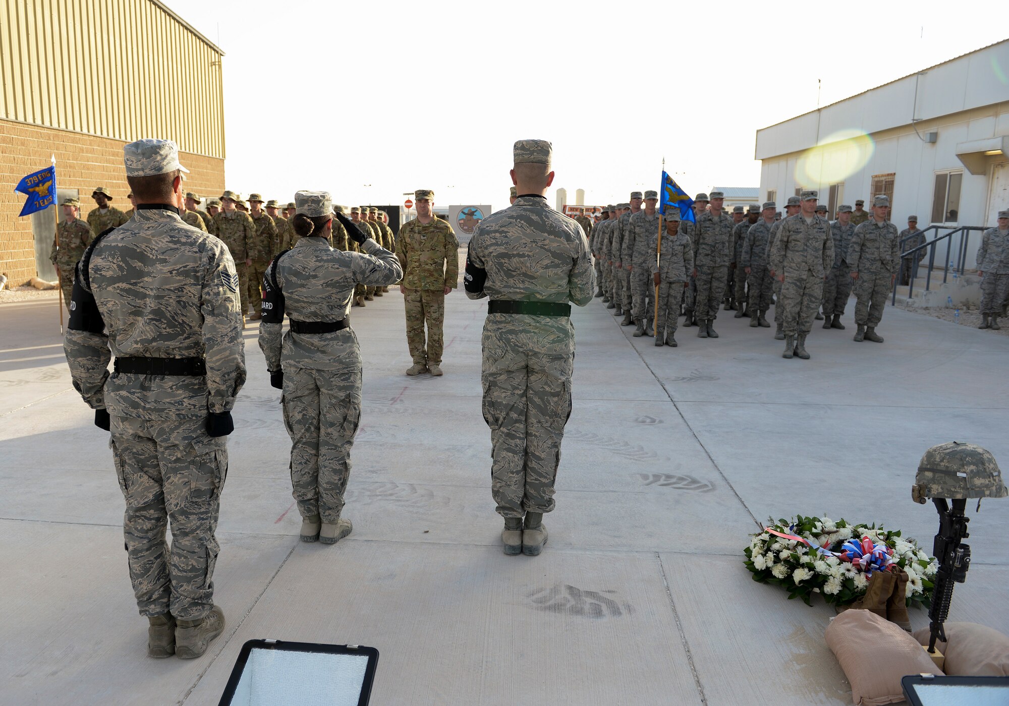 U.S. Air Force Airmen 1st Class Jessica Kornmann, 379th Air Expeditionary Wing Honor Guard, salutes a formation made up of members from Al Udeid Air Base after retiring the American Flag while fellow members of the honor guard stand by at Al Udeid Air Base, Qatar, May 29, 2017. The flag retirement was part of a Memorial Day Retreat Ceremony held in honor of those who have died while in military service. (U.S. Air Force photo by Tech. Sgt. Bradly A. Schneider/Released)