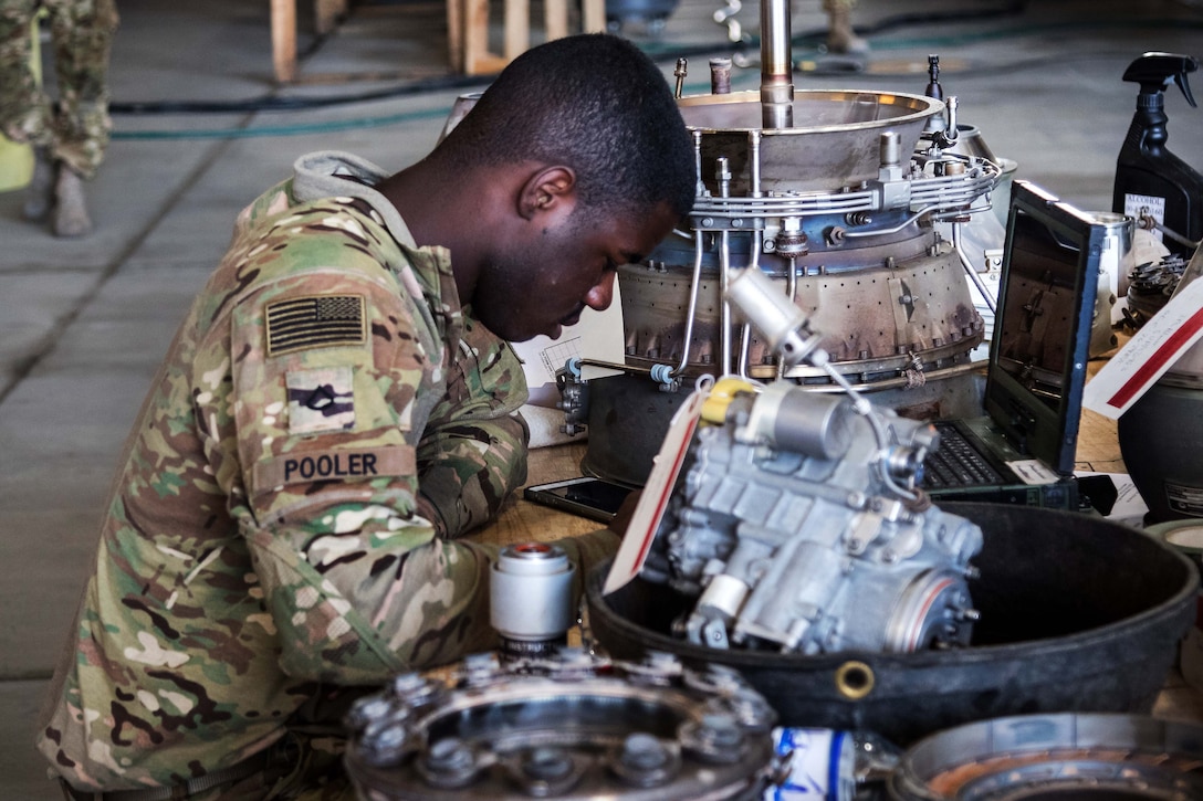 A soldier performs maintenance on an HH-60 Black Hawk helicopter engine at Bagram Airfield, Afghanistan, May 25, 2017. Army photo by Capt. Brian Harris   