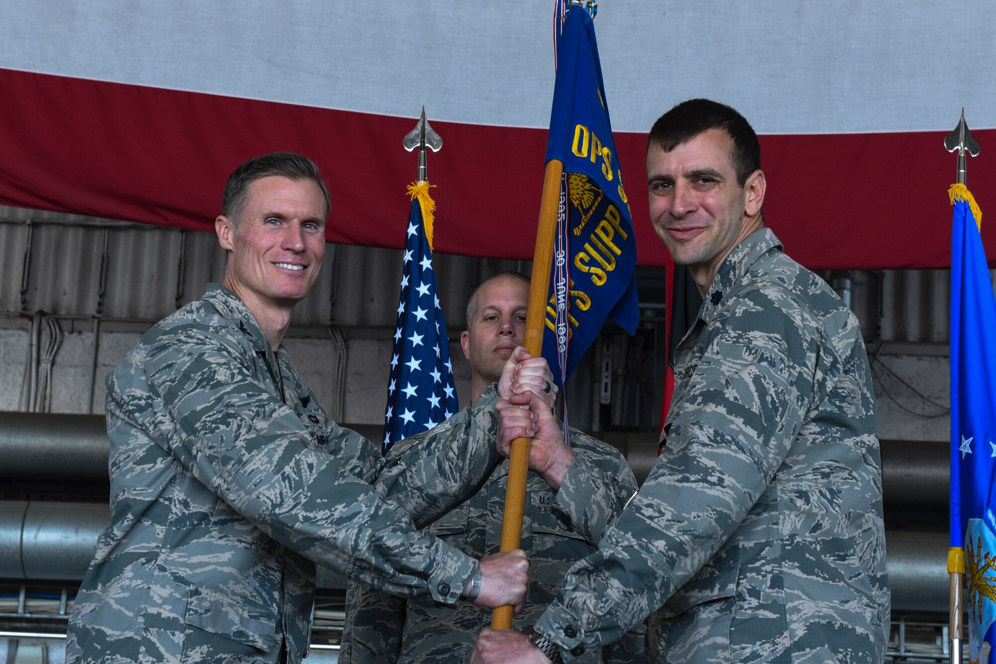 U.S. Air Force Col. Michael Thompson, 52nd Operations Group commander, left, gives the ceremonial guidon to U.S. Air Force Lt. Col. Joshua Kubacz, incoming 52nd Operations Support Squadron commander, during the 52nd OSS change of command ceremony on Spangdahlem Air Base, Germany, May 19, 2017. (U.S. Air Force photo by Senior Airman Dawn M. Weber)