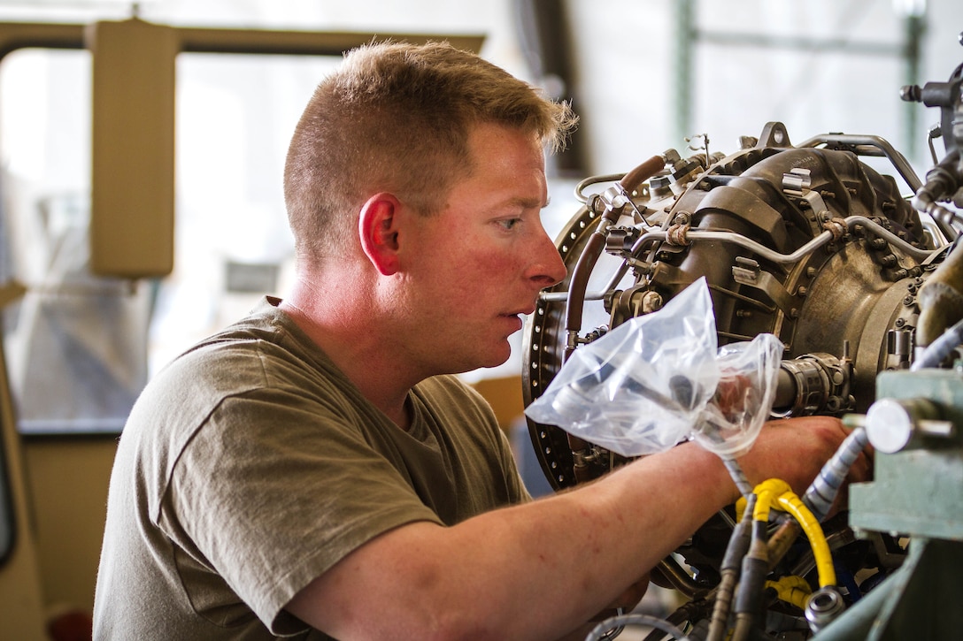 A soldier performs maintenance on an HH-60 Black Hawk helicopter engine at Bagram Airfield, Afghanistan, May 25, 2017. Army photo by Capt. Brian Harris