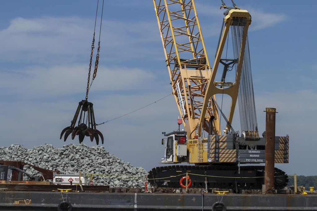 MATHEWS COUNTY, VA – Contractors use a crane to place granite along the bottom of the Piankatank River near Gwynn, Virginia.  The granite is being used to create 25 acres of new sanctuary reef habitat for oysters in the river.  (U.S. Army photo/Patrick Bloodgood)