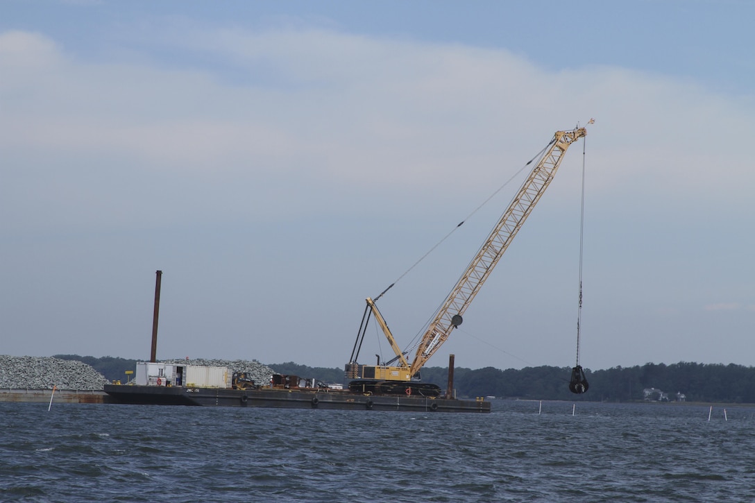 MATHEWS COUNTY, VA – Contractors use a crane to place granite along the bottom of the Piankatank River near Gwynn, Virginia.  The granite is being used to create 25 acres of new sanctuary reef habitat for oysters in the river.  (U.S. Army photo/Patrick Bloodgood)