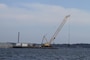 MATHEWS COUNTY, VA – Contractors use a crane to place granite along the bottom of the Piankatank River near Gwynn, Virginia.  The granite is being used to create 25 acres of new sanctuary reef habitat for oysters in the river.  (U.S. Army photo/Patrick Bloodgood)