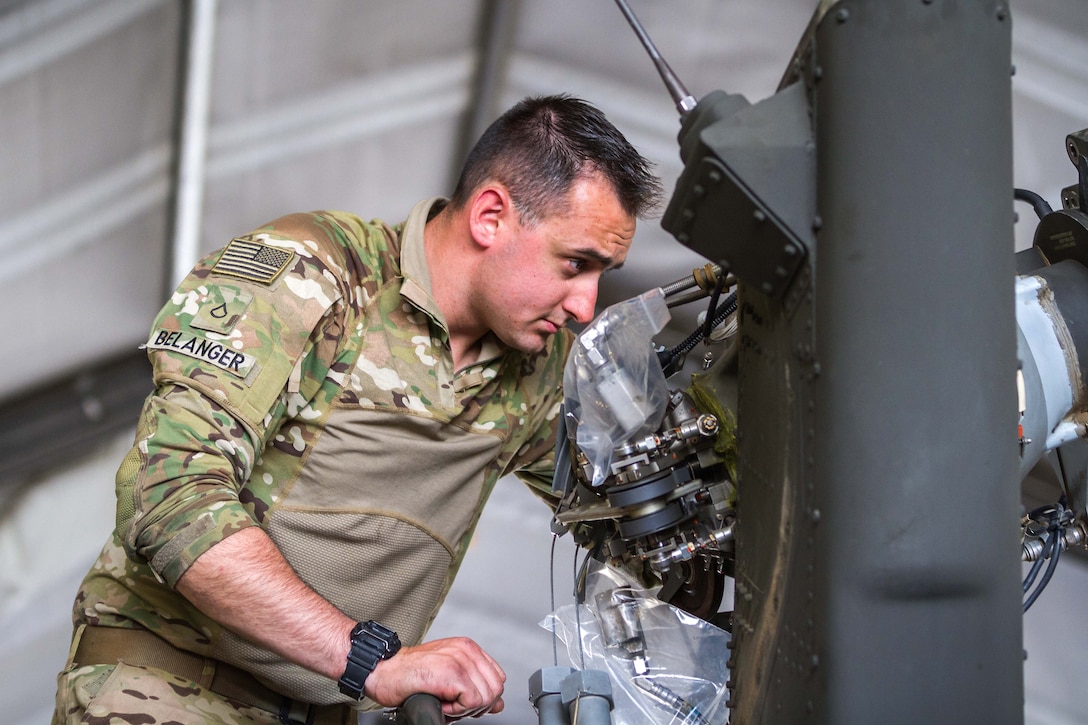 A soldier inspects the tail rotor housing during maintenance on an HH-60 Black Hawk helicopter at Bagram Airfield, Afghanistan, May 25, 2017. Army photo by Capt. Brian Harris