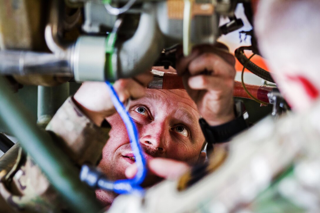 A soldier performs maintenance on an HH-60 Black Hawk helicopter engine at Bagram Airfield, Afghanistan, May 25, 2017. Army photo by Capt. Brian Harris                                                           